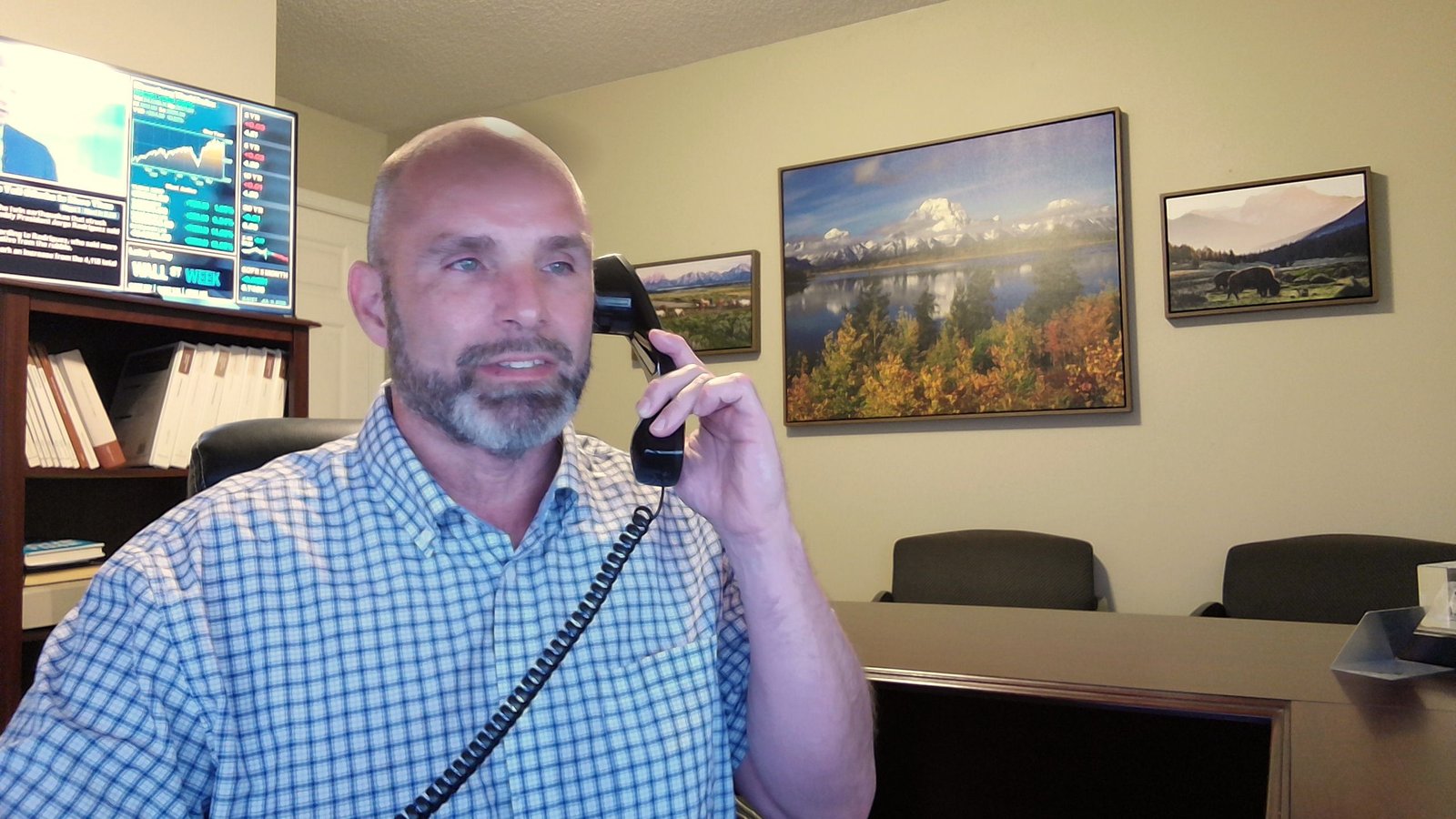 David J. Schwartz on the phone with a client in his office